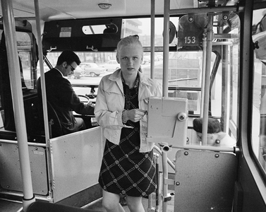 851220 Afbeelding van een meisje dat gebruik maakt van de nieuwe stempelautomaat in een stadsbus van het Gemeentelijke ...